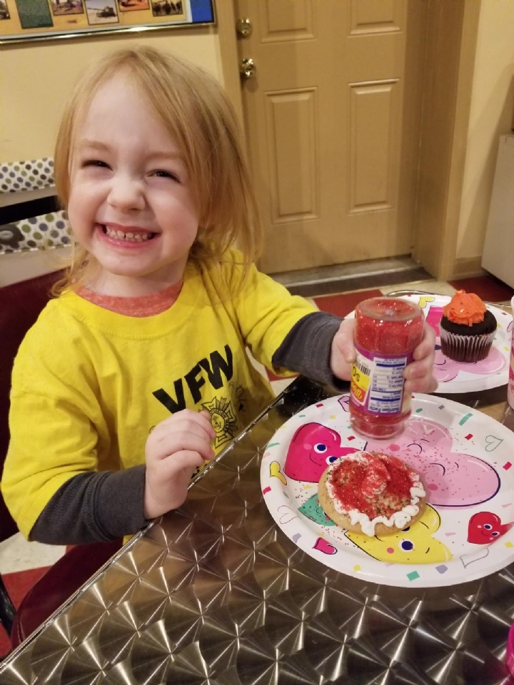 Our commanders daughter, making cookies for Valentineâ€™s Day with other children at the post. 